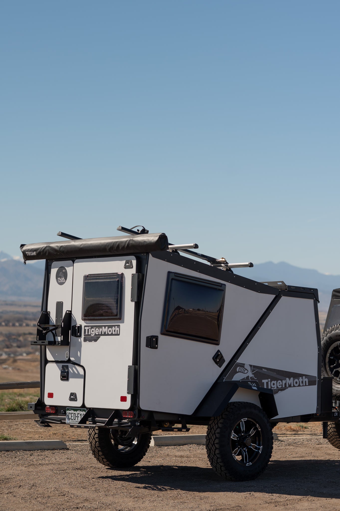 Compact, off-road TigerMoth overland camper, a unique rv rental for outdoor adventures. Scenic mountain views.