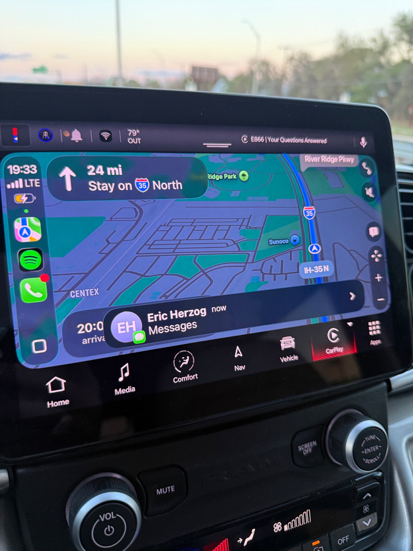 An RV rental's infotainment screen displays CarPlay navigation on IH-35 N, 24 miles left, with a message from Eric Herzog. Vehicle controls are visible below.