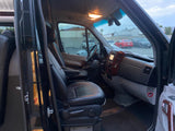 An RV rental's interior: view from the passenger side showing the spacious cockpit and front seats.