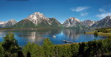 Stunning mountain-lake vista with a boat and dock. Your RV rental adventure awaits in this pristine national park.