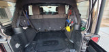 Rear cargo area of a customized Jeep Wrangler, featuring organized tools & recovery gear. Ideal for adventures beyond rv rental.