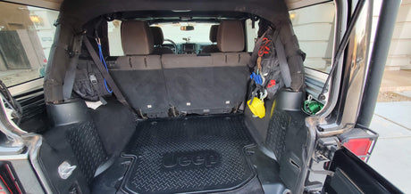Rear cargo area of a customized Jeep Wrangler, featuring organized tools & recovery gear. Ideal for adventures beyond rv rental.