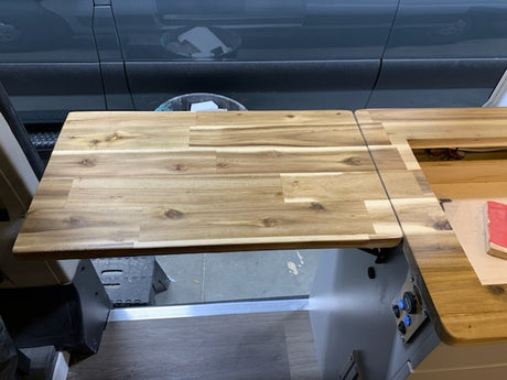 Functional wooden flip-up table in an RV rental, maximizing space for dining or work within the vehicle.