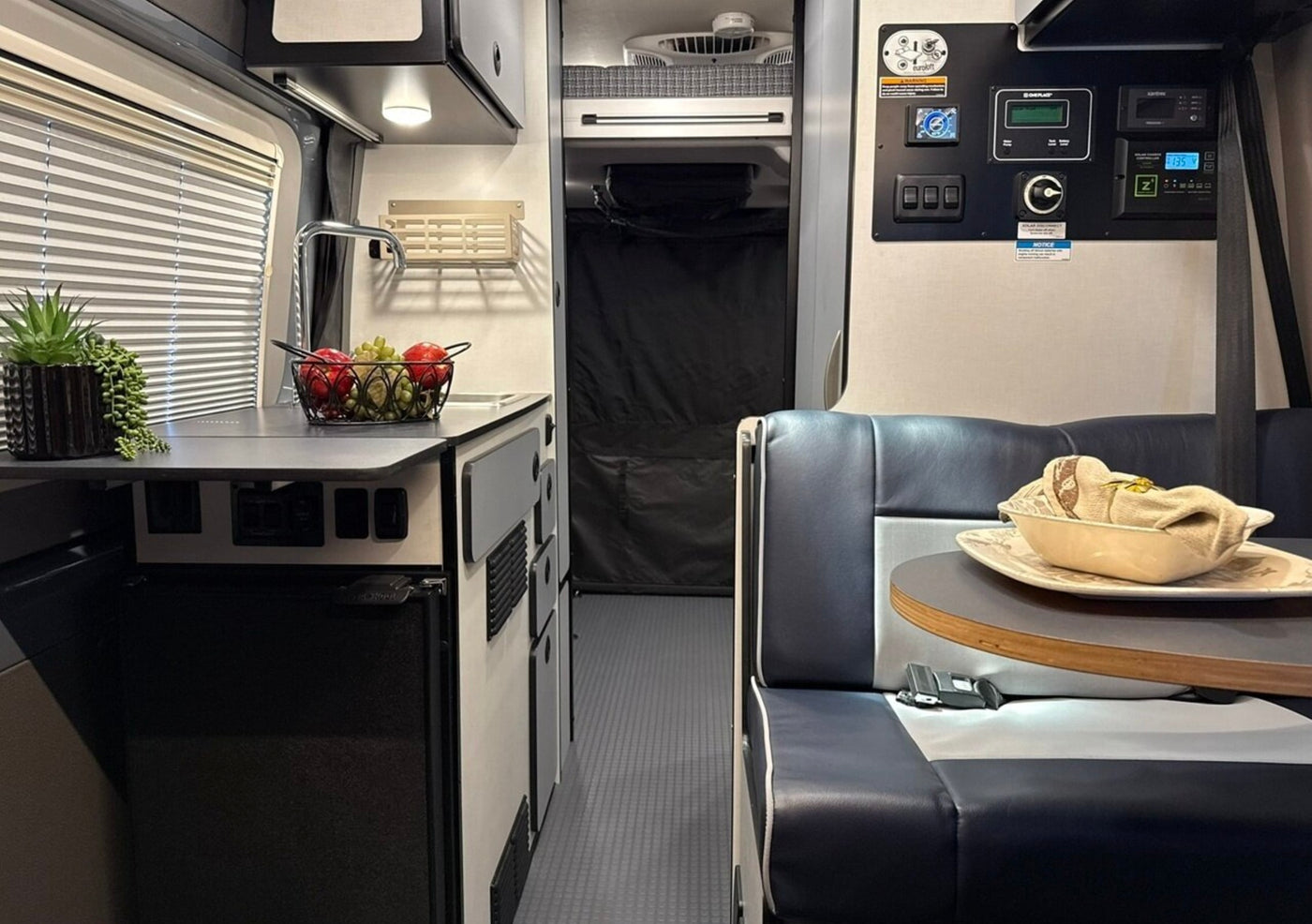  inviting outdoor adventure. Picnic table & chair nearby.|White RV rental camper van with bikes on rear — photo 2