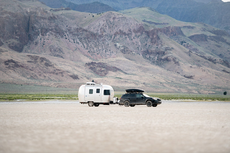  plus a small kitchen.|A sleek silver Airstream rv rental awaits in a serene forest. Its door is open — photo 5