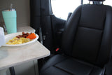 Breakfast in an RV rental: scrambled eggs, sausages, and bell pepper on a counter, with a tumbler and vehicle seat visible.