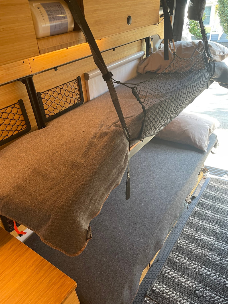 Cozy rv rental interior featuring a versatile bunk bed system, bamboo wood details, and practical storage nets. Ready for adventure! — photo 5