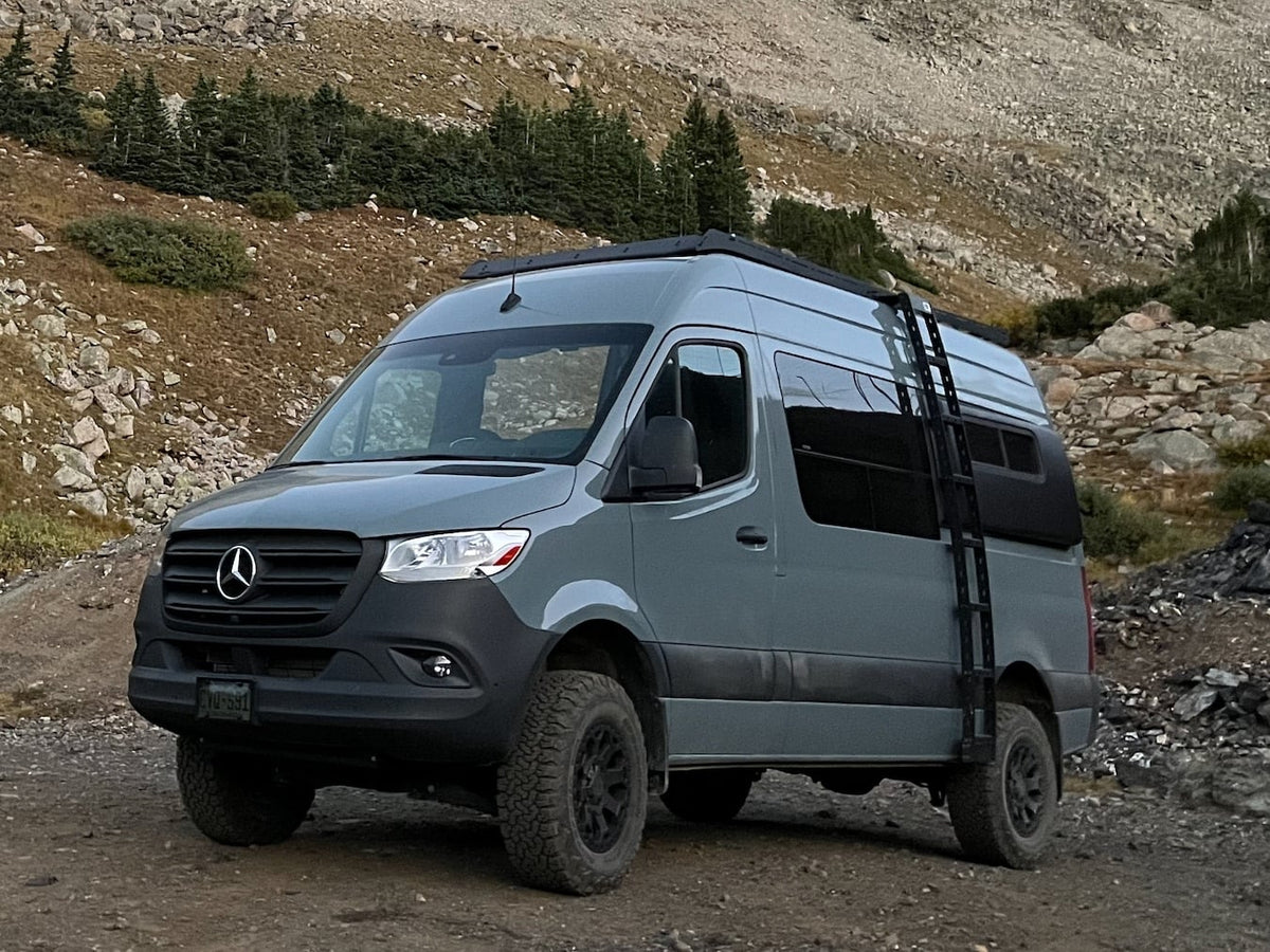 A gray off-road Mercedes Sprinter camper van