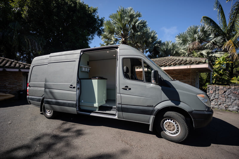 Grey Sprinter camper van conversion for RV rental, side door open to light green interior kitchen. — photo 10