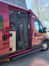 Maroon Winnebago camper van with open side door revealing mesh screen and interior, ideal for rv rental.