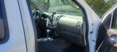 Front interior of a white SUV/truck, displaying dashboard, steering wheel, and console. Ideal for your next RV rental.