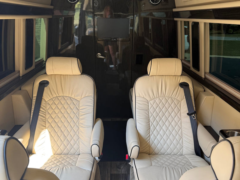  parked in a sunny driveway.|This sleek black luxury RV rental van is seen parked — photo 3