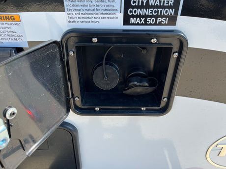 RV rental water utility panel with open access. Details for potable water fill, city water connection (Max 50 PSI), and safety warnings.