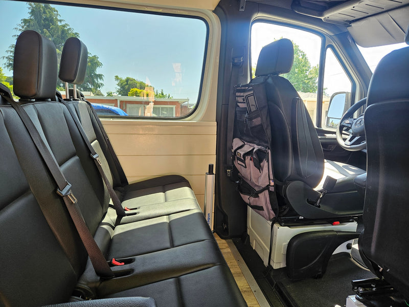 RV rental interior: comfy black passenger seats, side window, Lagun table mount, & handy storage bag. Ready for your journey! — photo 9