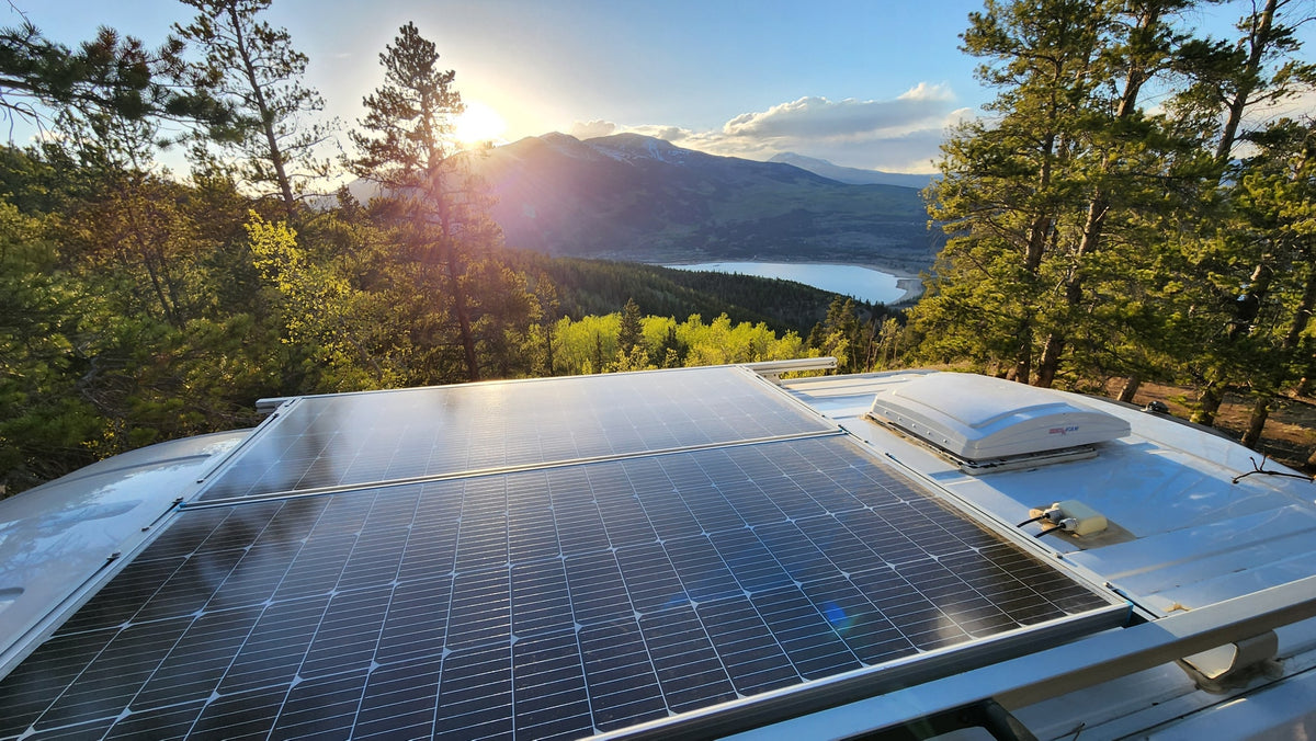 RV rental with rooftop solar panels, offering stunning views of a mountain lake at sunset, perfect for off-grid travel. — photo 13