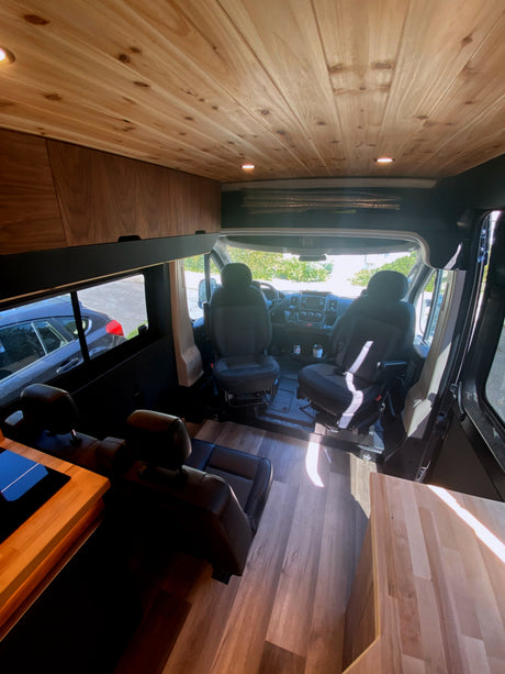Step inside this cozy rv rental! Features wood paneling, comfortable swivel seating, and a spacious living area.
