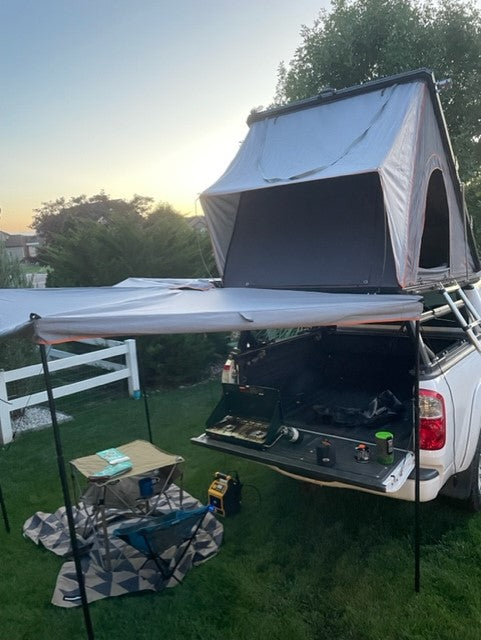 Enjoy an RV rental adventure! This pickup truck camping setup includes a rooftop tent, awning, and tailgate kitchen. — photo 14