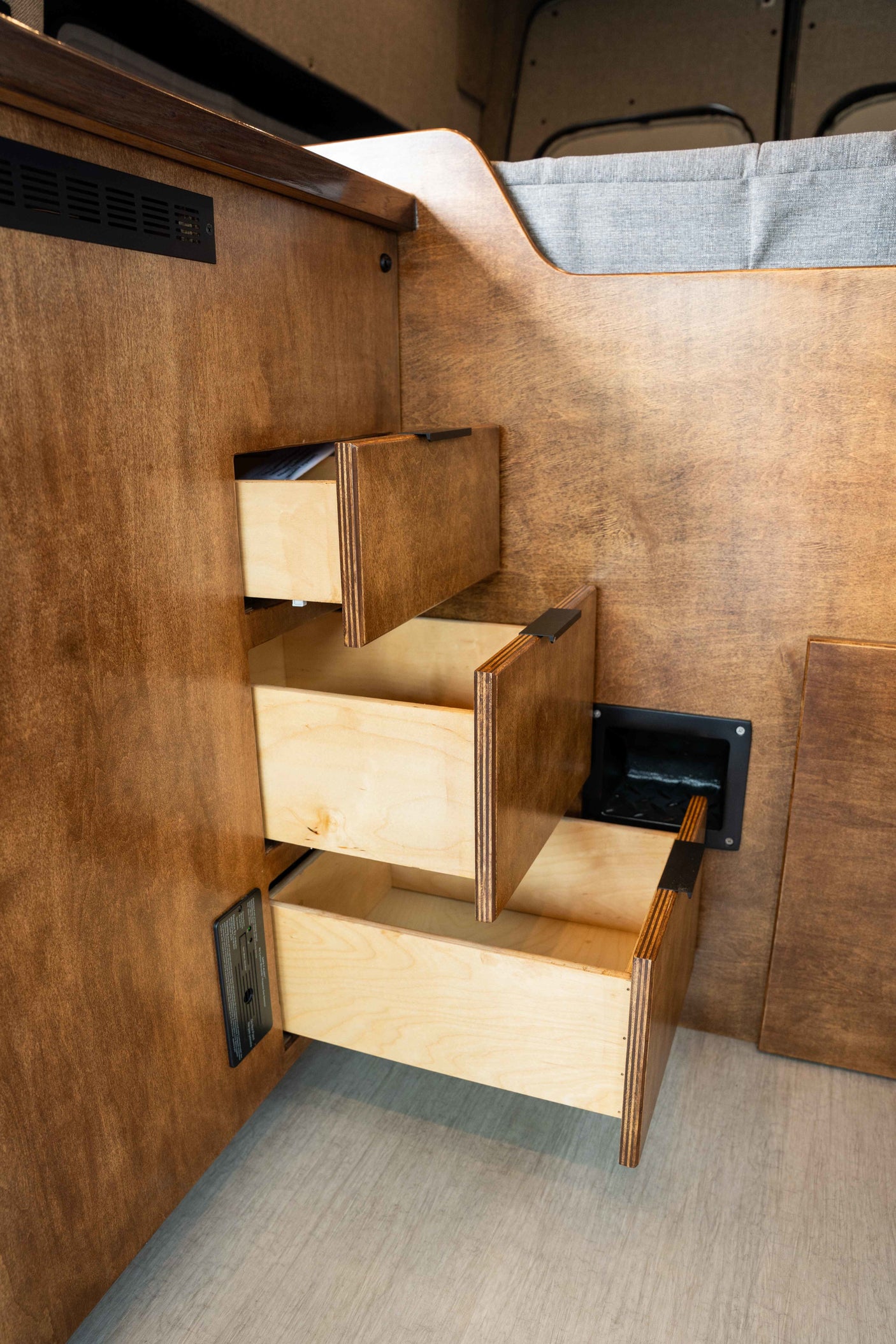 RV rental with clever wood stair-drawers providing bed access and hidden storage.