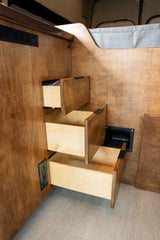 RV rental with clever wood stair-drawers providing bed access and hidden storage.
