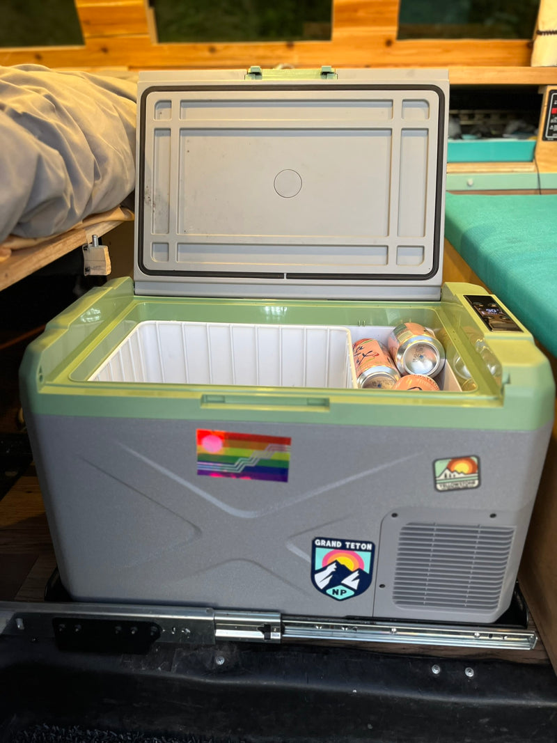 Portable fridge open in an RV rental, showing drinks inside. Ideal for travel and camping adventures. — photo 17