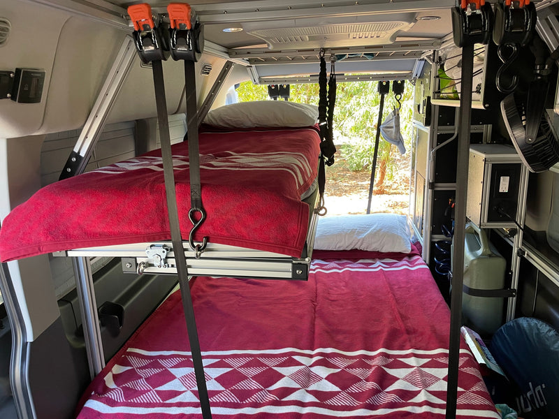 Inside an RV rental: a compact and organized camper interior with two cozy bunk beds, providing comfortable sleeping space. — photo 7