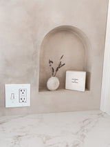 Cozy RV rental interior design: a built-in wall niche with dried lavender, positive decor, and a white countertop.