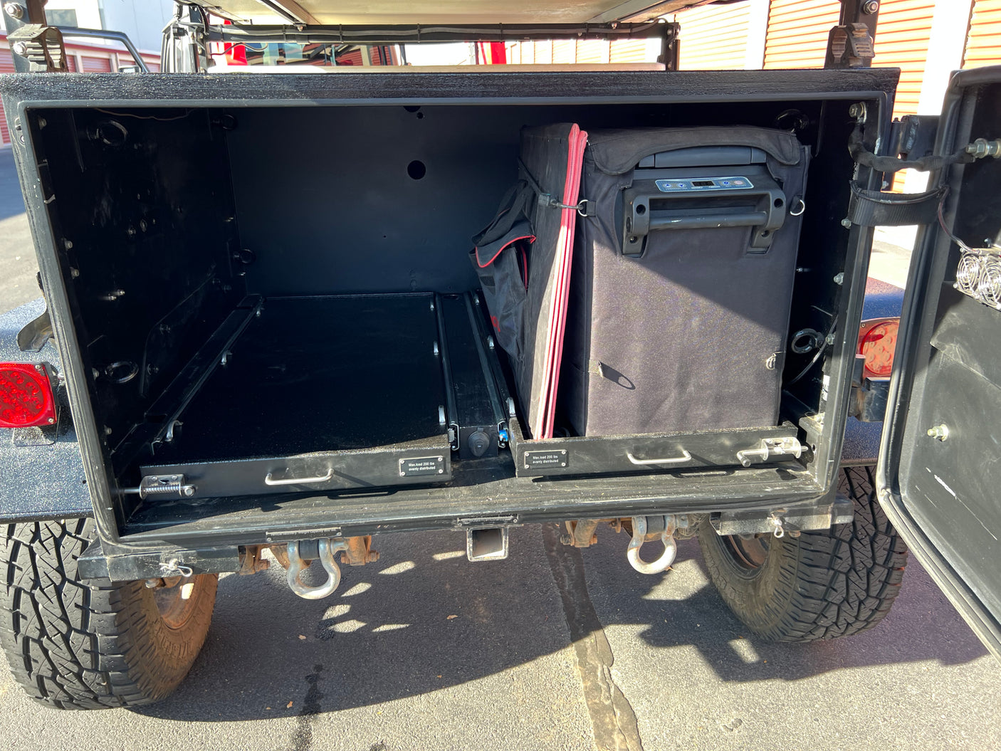 Maximize adventure with this RV rental! Rear storage features pull-out trays, portable fridge, and robust off-road utility.