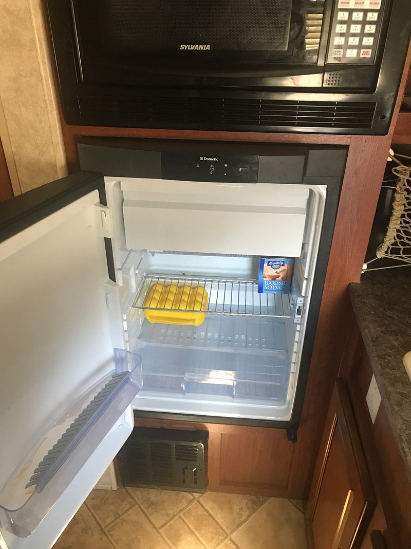  and windows with curtains for comfortable on-the-go living.|Bright RV rental interior: a compact kitchen with sink/stove — photo 9