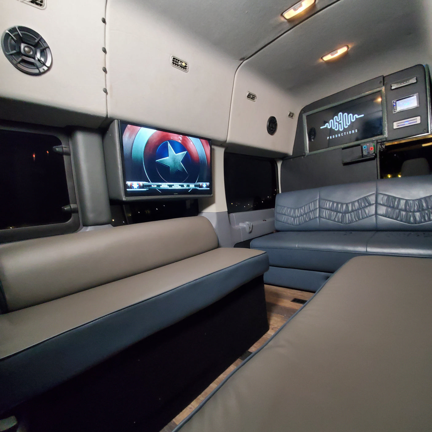 This luxury RV rental offers a spacious interior with Captain America on screen, plush two-tone seating, and custom lighting.