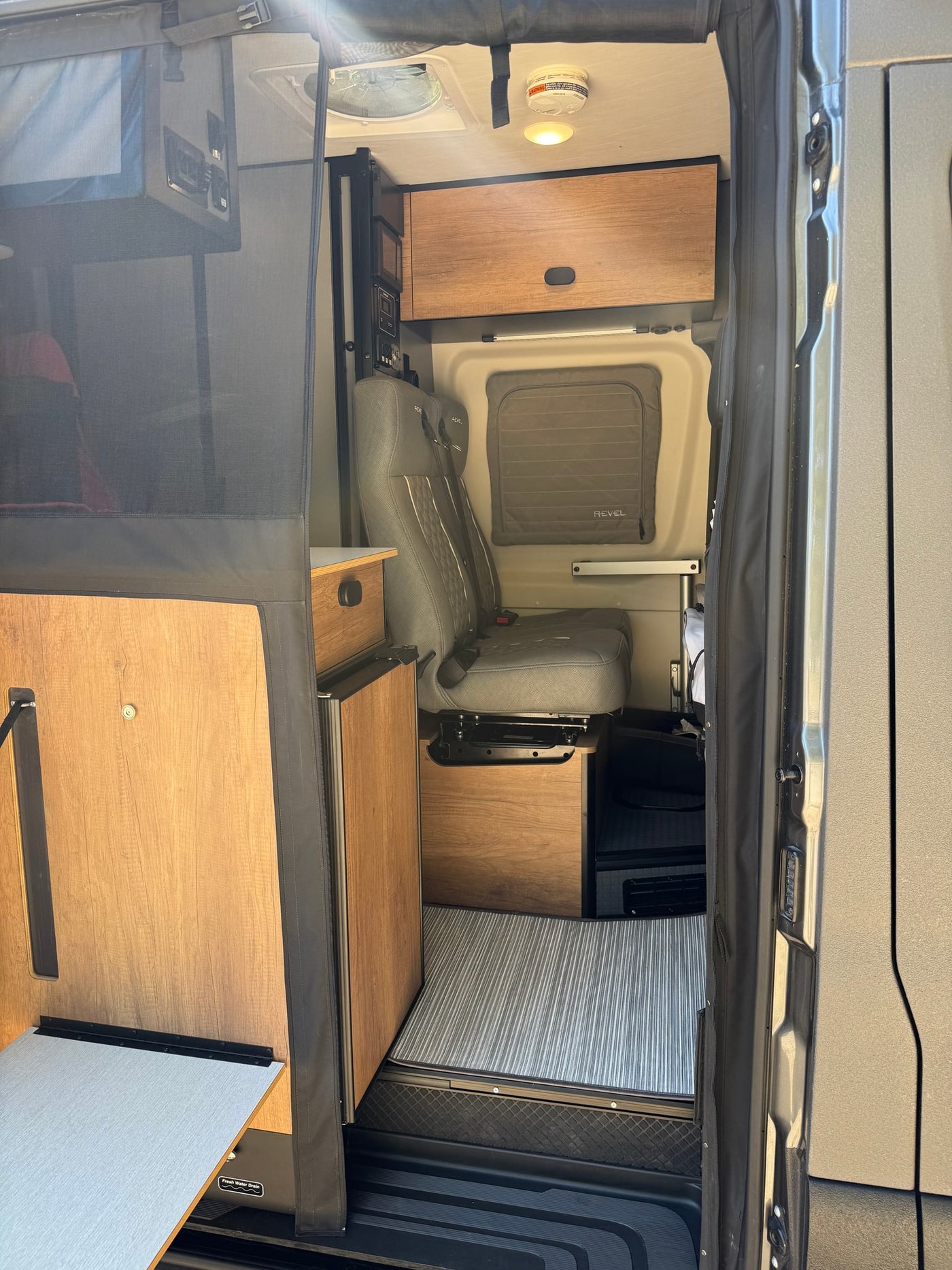  perfect for adventure.|Spacious rv rental van ready for adventure. Open doors reveal bed & gear — photo 13