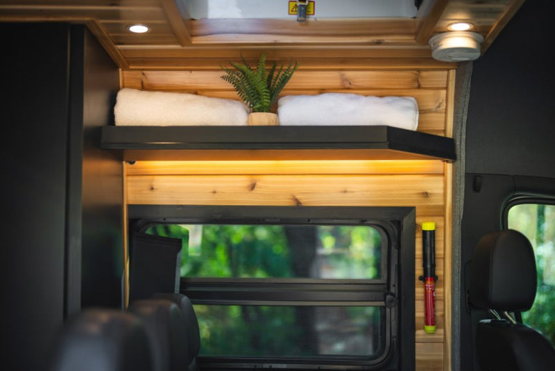 perfect for comfortable road trip adventures.|Cozy RV rental interior featuring a modern kitchen with black cabinets — photo 9
