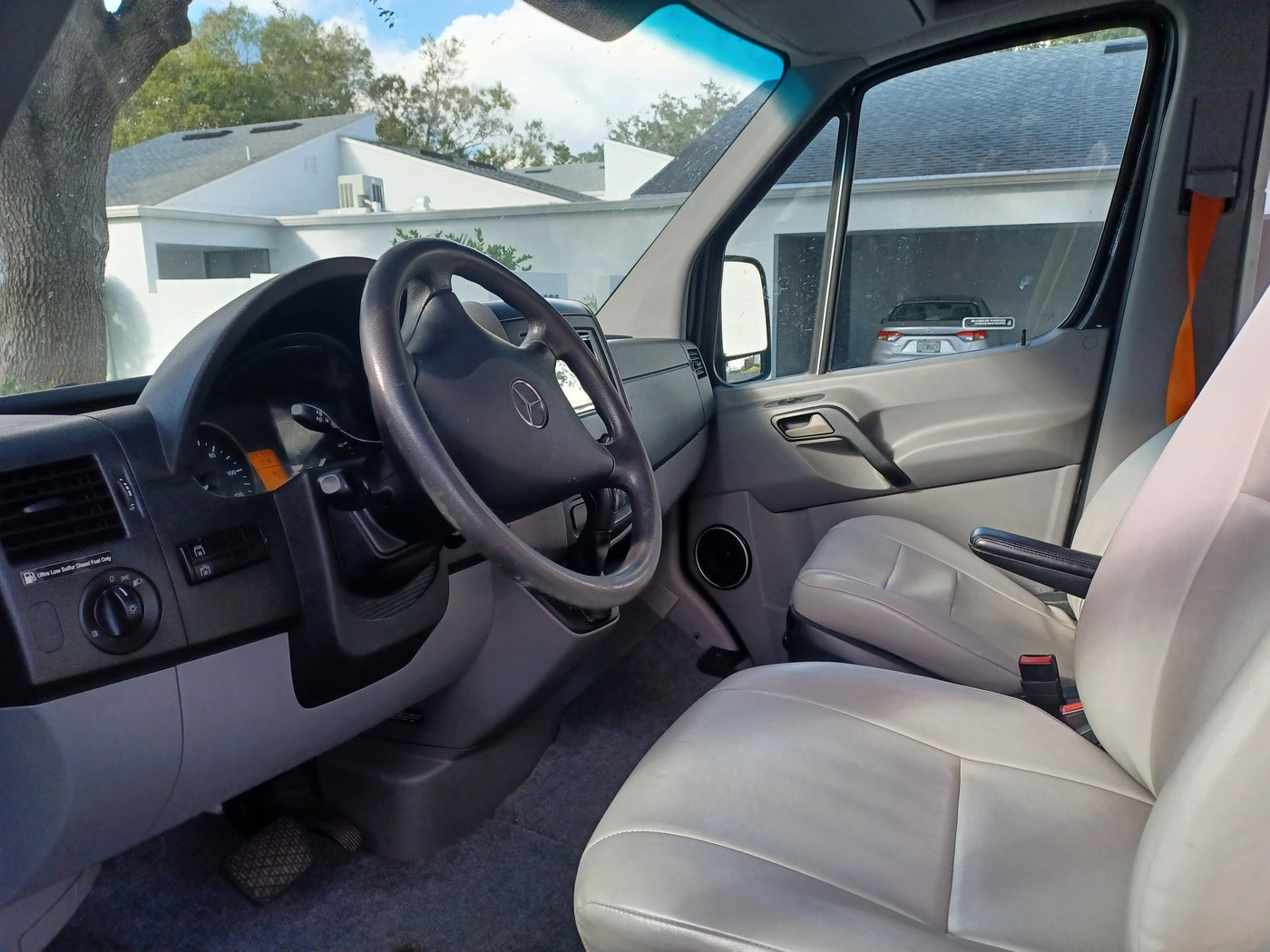 RV rental: Mercedes-Benz van interior, featuring dashboard with diesel fuel warning, steering wheel, & light seats. — photo 8