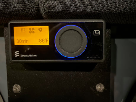 Eberspächer heater/fan control panel in an RV rental, displaying 86°F, 30min timer, with a blue glowing dial.