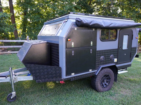  and a pop-up roof. Ideal for camping adventures.|RV rental interior: a pop-top camper's modern design with wall-mounted TV