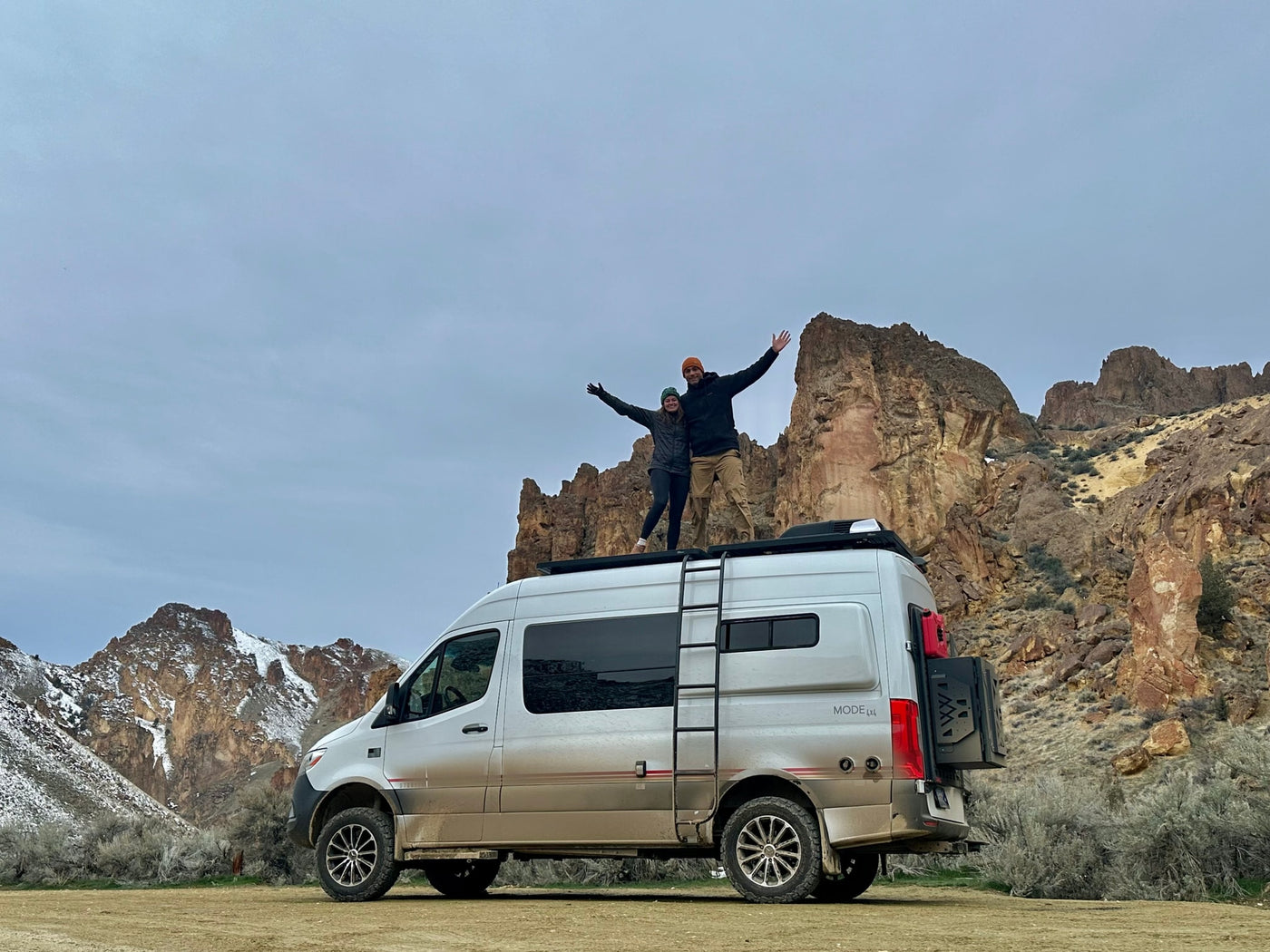  and a picnic table.|Night sky RV rental: A modern camper van under the stunning aurora borealis with trees silhouetted against purple light.|Inside an RV rental — photo 16