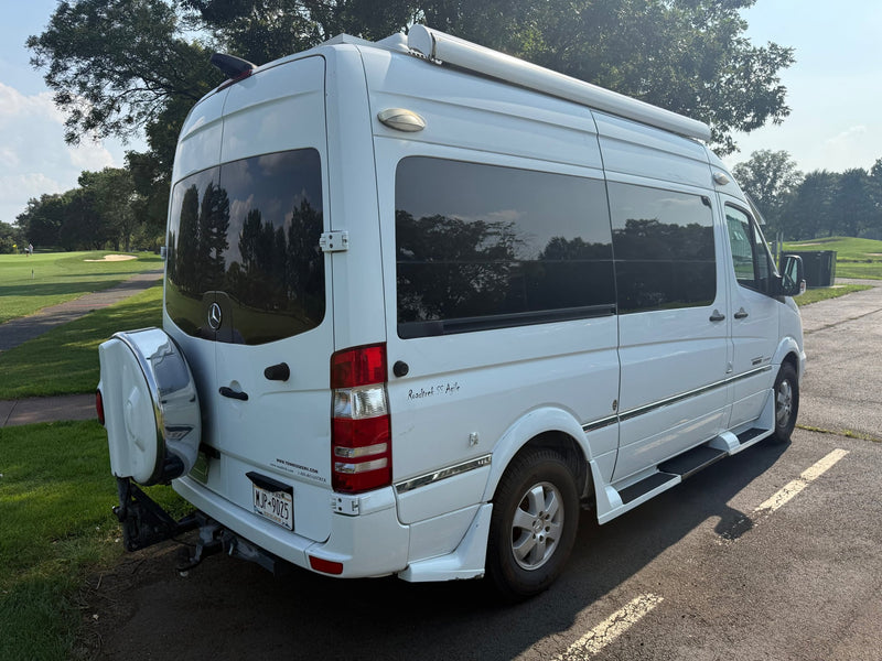  parked on asphalt next to grass under a blue sky with trees.|White Roadtrek SS Agile rv rental campervan (Mercedes-Benz Sprinter) parked outdoors — photo 5