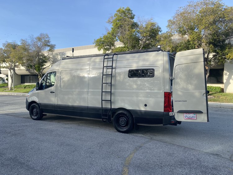  and a wooden floor mat for comfortable travel.|RV rental van: Overhead microwave — photo 8