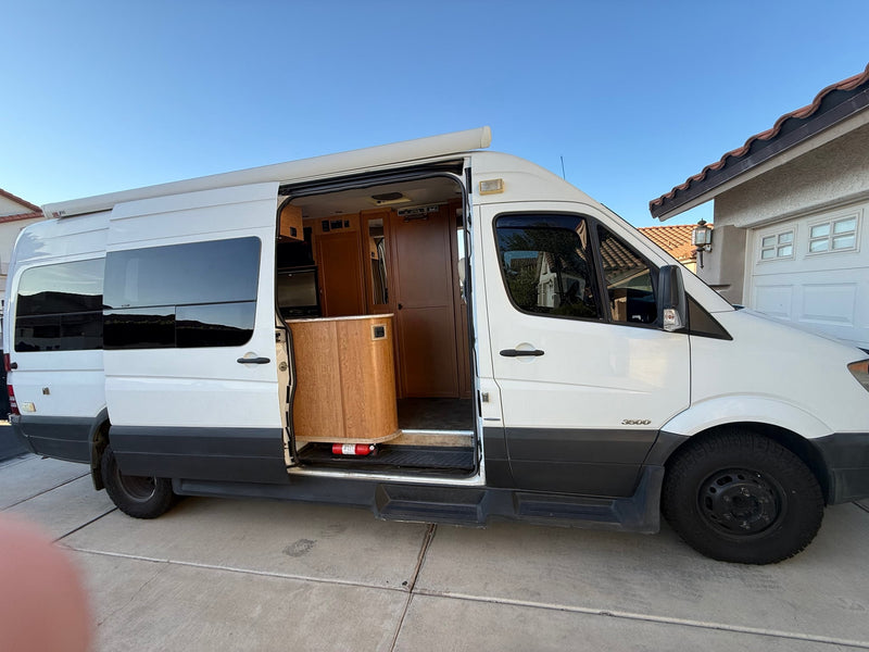 White Sprinter van RV rental with side door open — photo 1