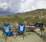  during desert camping. A distant RV rental promises more outdoor travel fun.|An SUV adapted for car camping is parked in a sunny