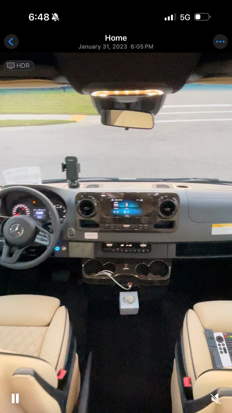  parked on a brick driveway with palm trees in a sunny setting.|Modern **RV rental** interior: Mercedes-Benz dashboard — photo 2