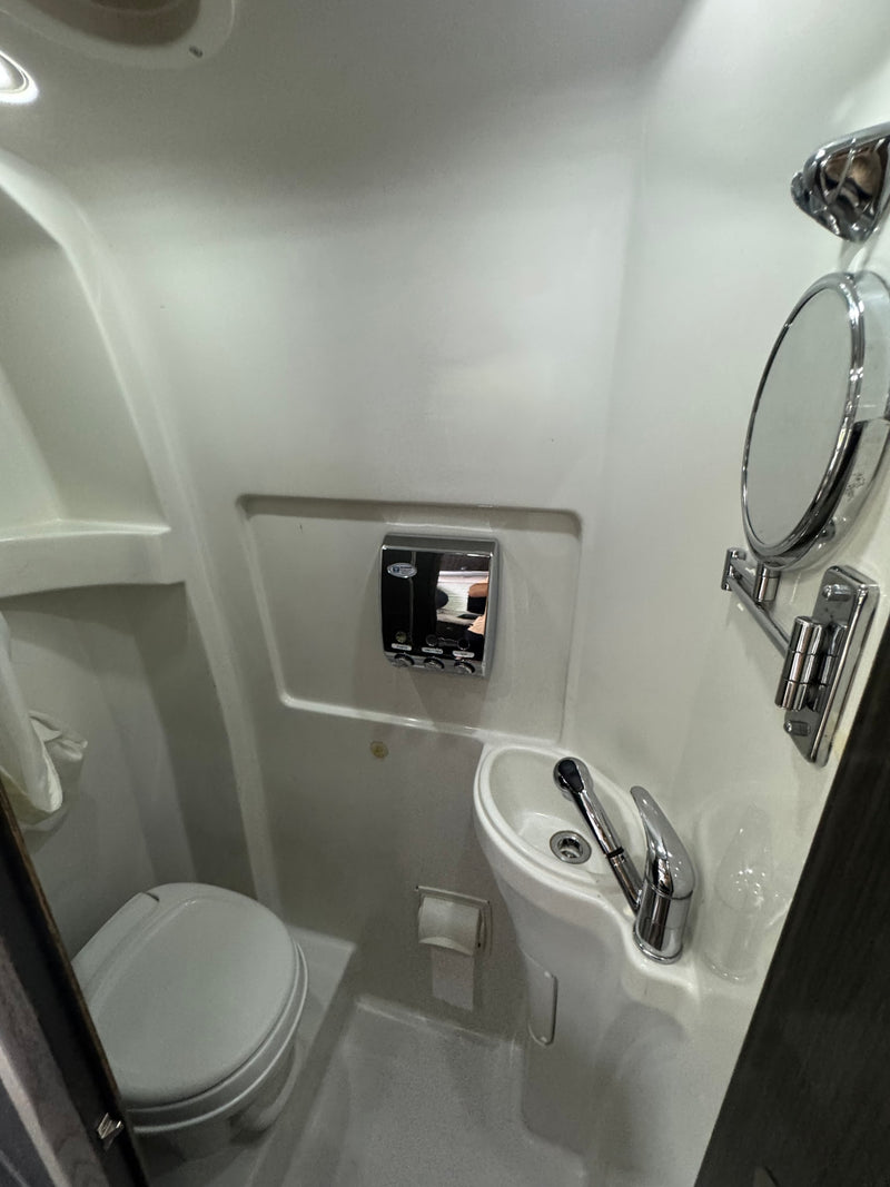 Compact RV rental wet bath featuring toilet, sink, and shower. Ideal for space-saving travel. — photo 6