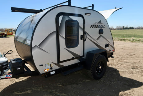 This Freesolo compact camper trailer, ideal for RV rental, features an off-road design, front window & roof rack.