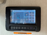 RV rental control panel showing tank levels, climate (68°F/70°F), and light settings with physical buttons below.