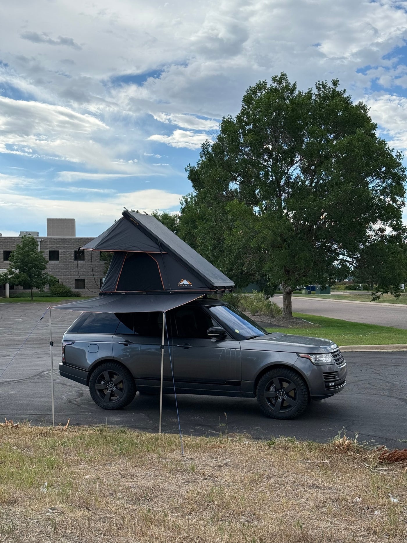 Dark grey Range Rover SUV with a rooftop tent and awning, perfect for your next rv rental or overlanding trip. — photo 5