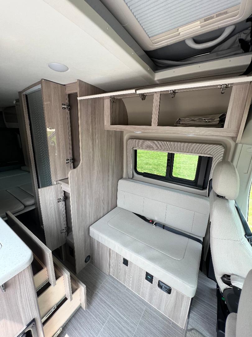  showcasing stunning red rock formations & natural arches.|Inside a gray rv rental camper van — photo 13