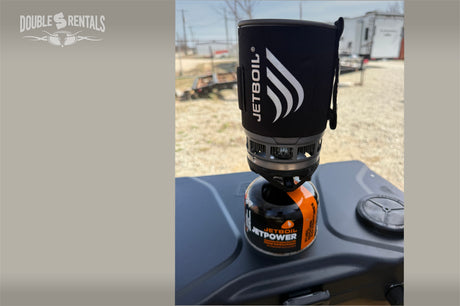 A Jetboil camping stove on an outdoor table, fueled up and ready for cooking at an RV rental site. Essential for outdoor adventures.