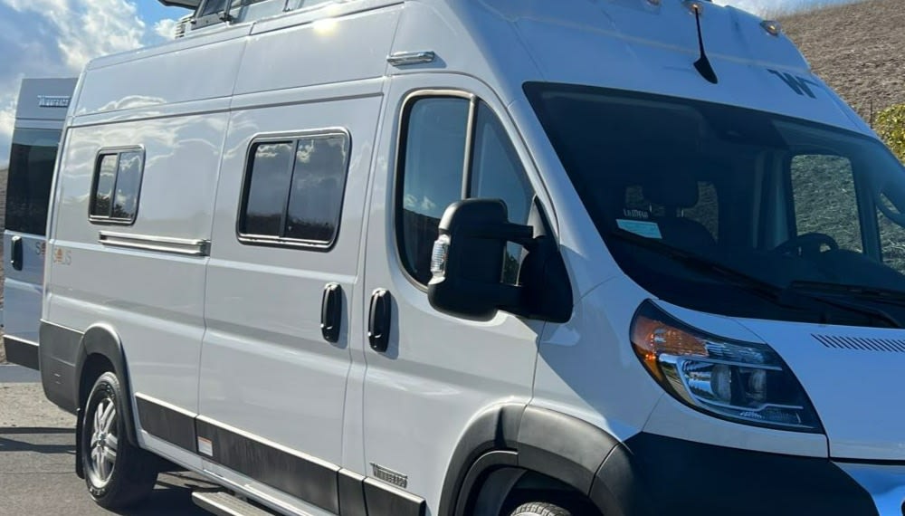 Explore in style with this white camper van rv rental. Its modern design features multiple side windows