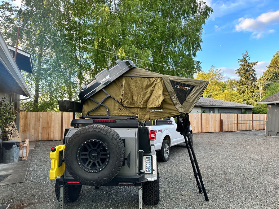  & stovetop for convenient off-grid camping.|Dark truck with an overland trailer and rooftop tent deployed