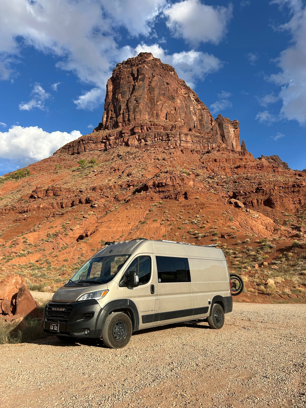 Explore stunning landscapes with an RV rental camper van parked at the base of a towering red rock mountain. — photo 6