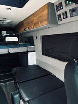 RV rental interior featuring a cozy bed, ample storage, and advanced power controls for a comfortable journey.